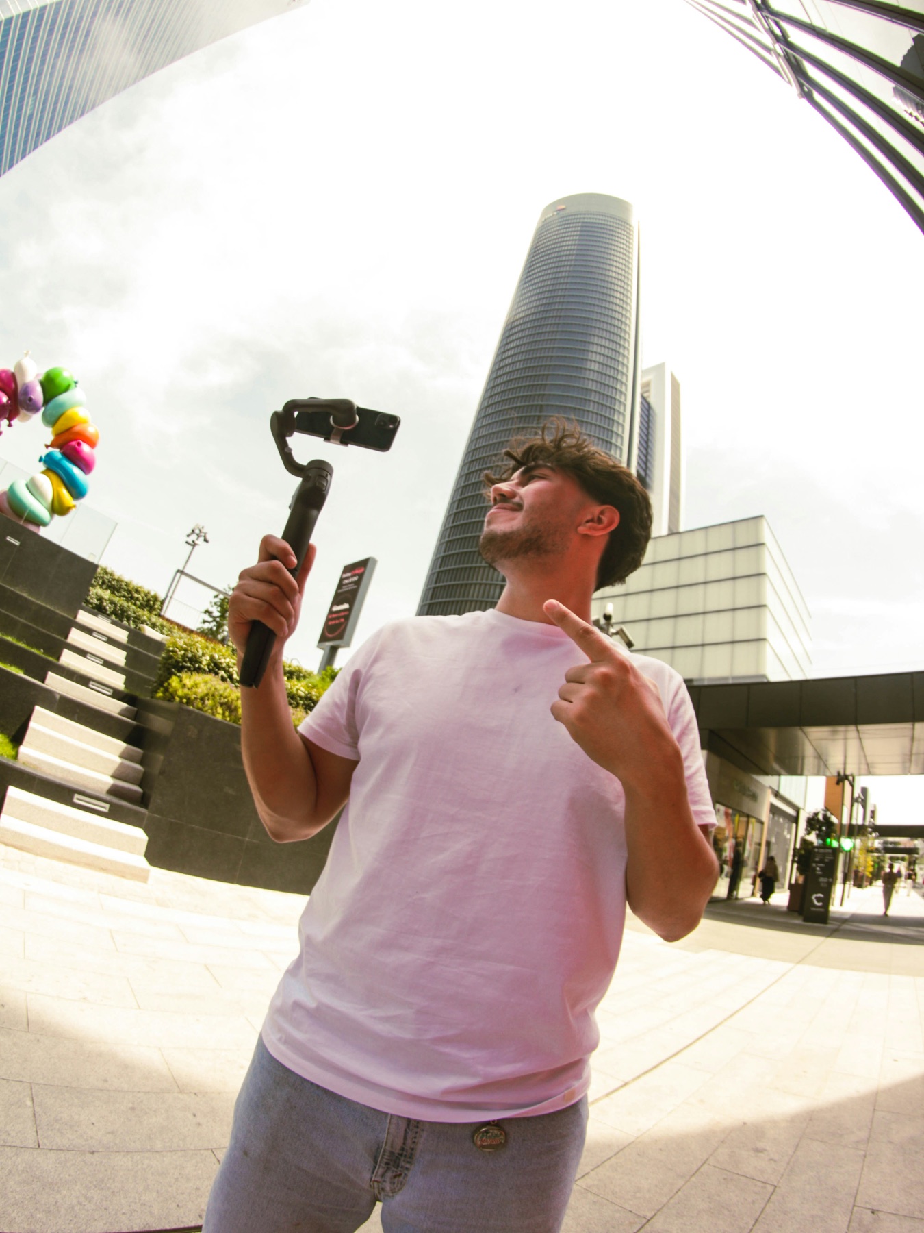 A person filming vertical content on a smartphone outdoors