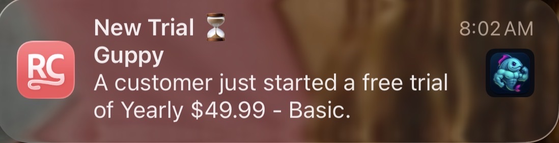 RevenueCat notification showing a Guppy customer starting a Yearly $49.99 free trial